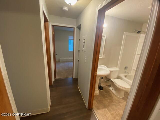 corridor featuring dark wood-type flooring