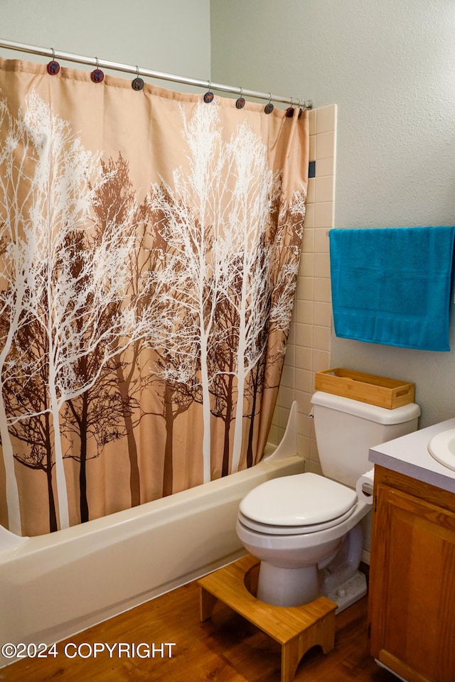 full bathroom featuring vanity, toilet, shower / bathtub combination with curtain, and hardwood / wood-style flooring