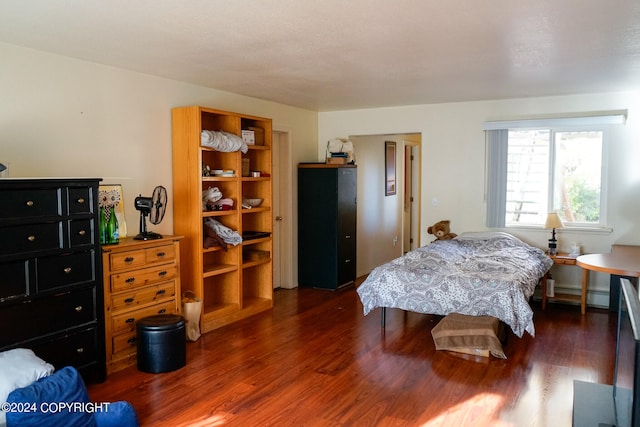 bedroom featuring a baseboard radiator and dark hardwood / wood-style floors