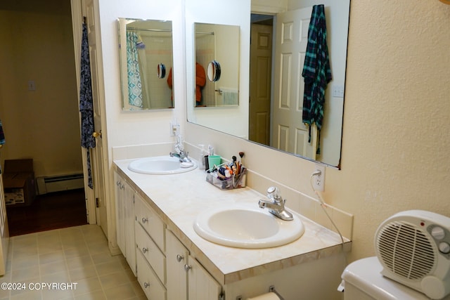 bathroom featuring a baseboard radiator, tile patterned floors, vanity, and toilet