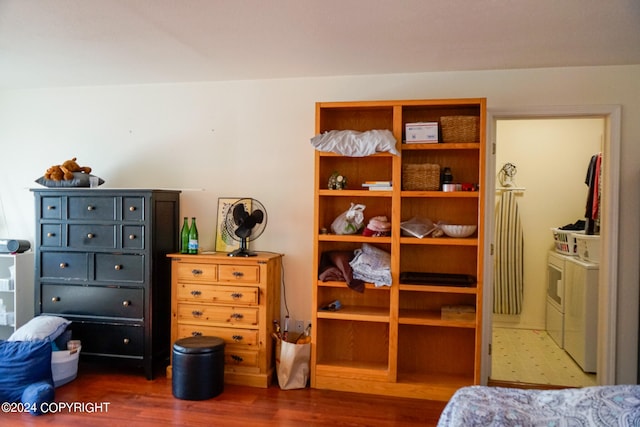 bedroom featuring washing machine and clothes dryer and dark wood-type flooring