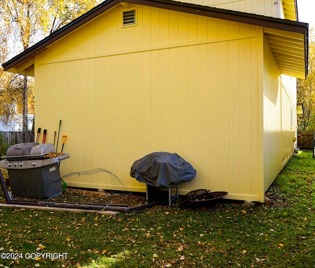 view of side of property with a lawn