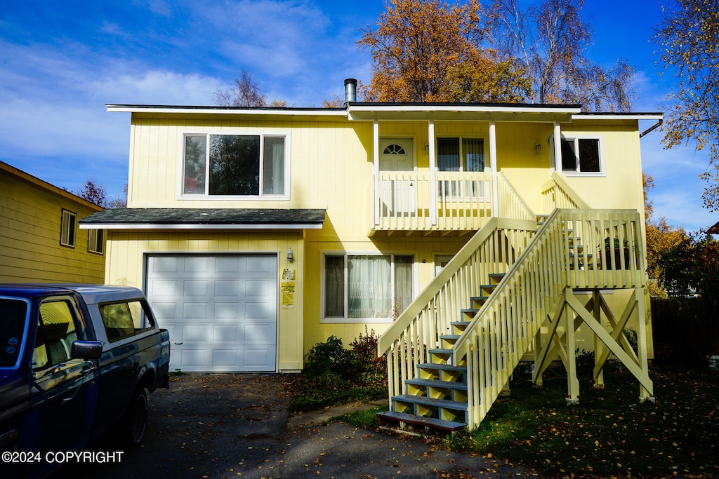 view of front of property with a porch and a garage