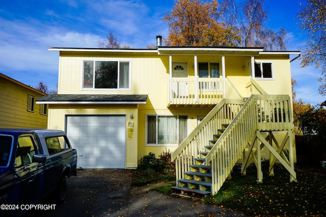 view of front of property with a porch and a garage