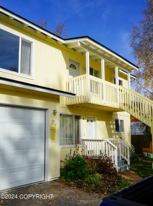 view of front facade with a balcony and a garage