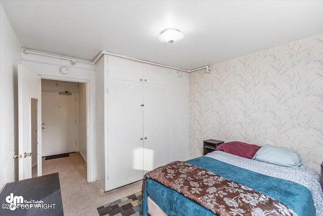 carpeted bedroom with a closet