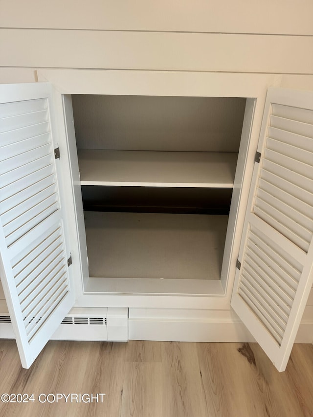 details featuring hardwood / wood-style flooring and a baseboard radiator