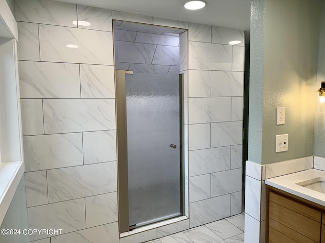 bathroom featuring walk in shower and vanity