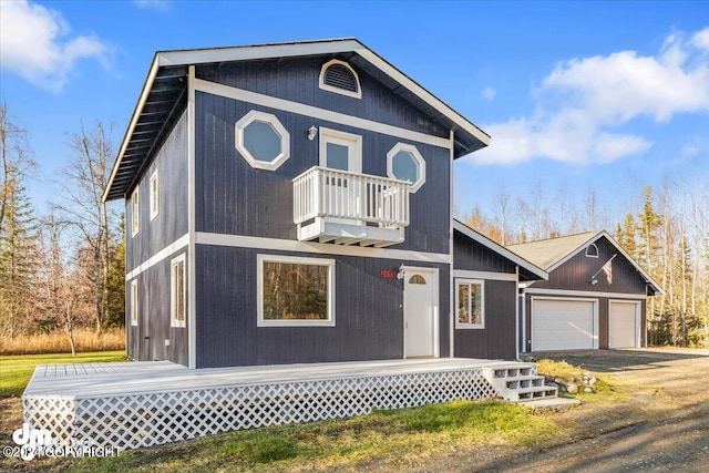 view of front of house featuring a garage and a balcony