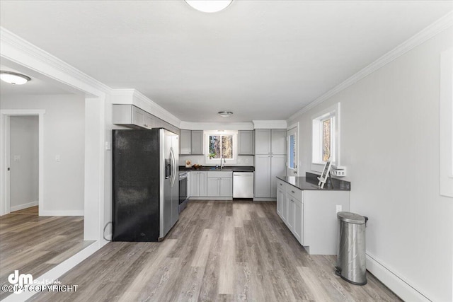 kitchen featuring gray cabinetry, stainless steel appliances, sink, and hardwood / wood-style floors