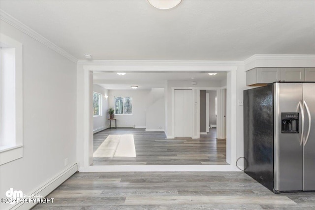 kitchen featuring gray cabinetry, a baseboard radiator, light wood-type flooring, crown molding, and stainless steel fridge with ice dispenser