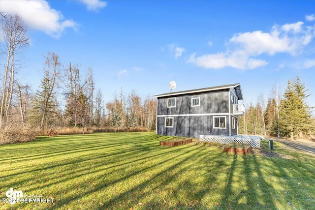 back of house with a lawn