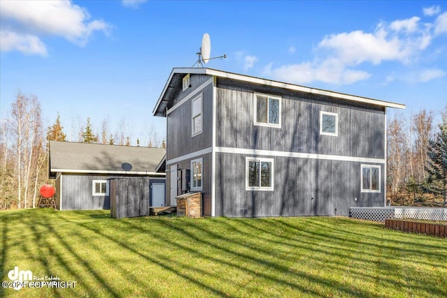 rear view of property with a lawn