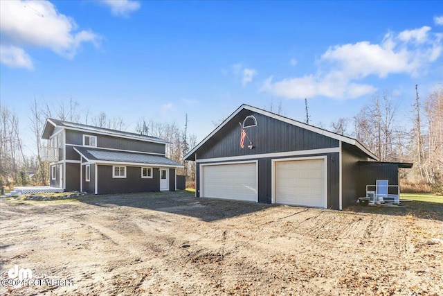 view of front of home featuring a garage and an outdoor structure