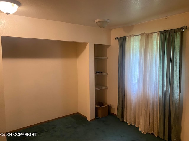 unfurnished bedroom featuring dark colored carpet