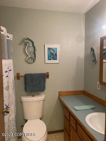1915 Dora Way, Seward, AK 99664 - full bathroom featuring vanity, toilet, tile patterned floors, baseboards, and a shower with shower curtain