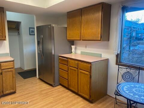 kitchen with light hardwood / wood-style flooring and stainless steel refrigerator with ice dispenser