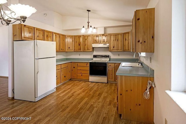 kitchen featuring hanging light fixtures, vaulted ceiling, white appliances, an inviting chandelier, and sink