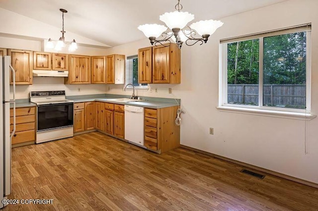 kitchen featuring pendant lighting, sink, white appliances, light wood-type flooring, and vaulted ceiling