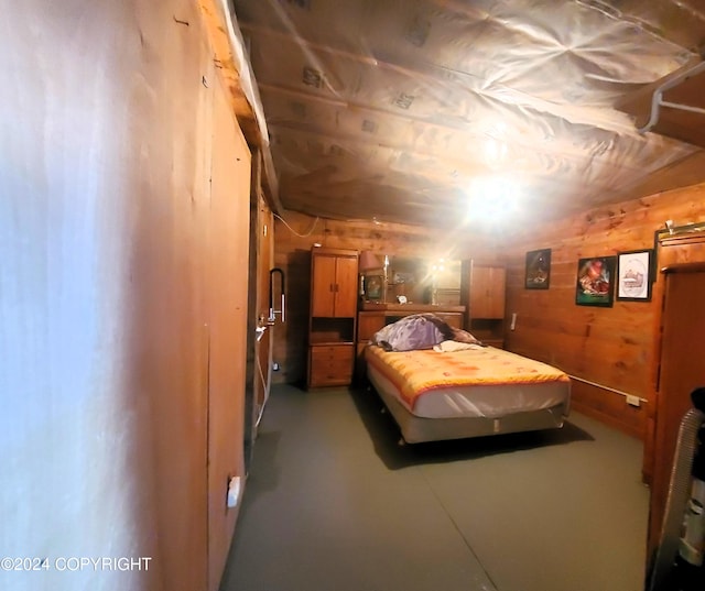 bedroom featuring wood walls