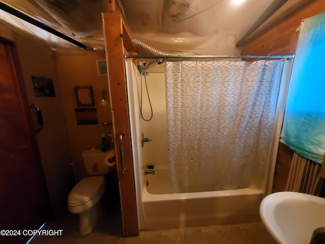 bathroom featuring shower / bath combo and toilet