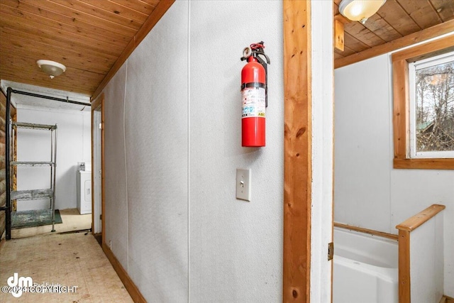 hall featuring washer / clothes dryer and wooden ceiling