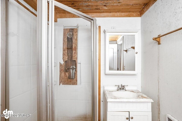 bathroom featuring vanity, wood ceiling, and a shower with shower door