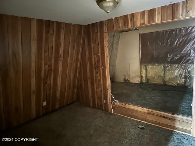 misc room featuring wooden walls