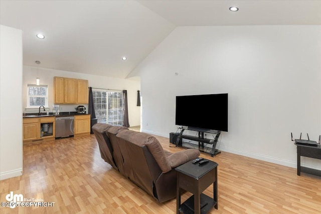 living room with high vaulted ceiling, sink, and light wood-type flooring