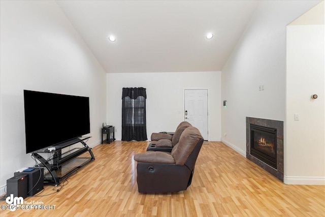 living room featuring high vaulted ceiling and light wood-type flooring