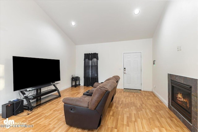 living room with high vaulted ceiling and light wood-type flooring