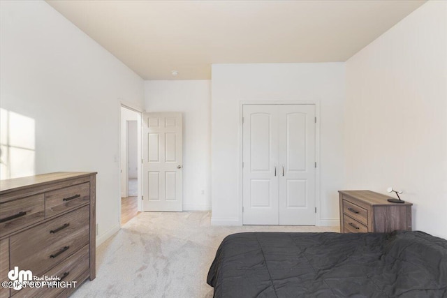 bedroom featuring a closet and light carpet