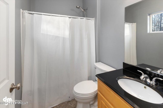 bathroom featuring vanity, toilet, and curtained shower