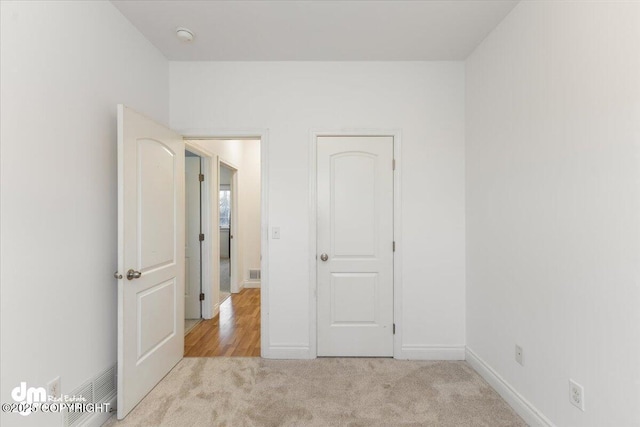 unfurnished bedroom with light carpet