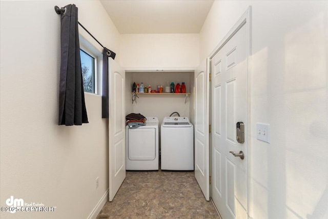 clothes washing area with washing machine and dryer