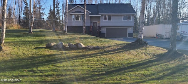 split foyer home with a garage and a front yard