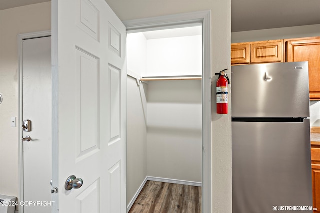 kitchen featuring wood finished floors and freestanding refrigerator