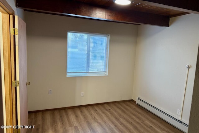 interior space featuring beam ceiling, light wood finished floors, baseboards, and baseboard heating