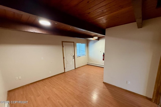 basement with wooden ceiling, a baseboard heating unit, baseboards, and wood finished floors