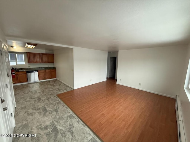 unfurnished living room featuring baseboards and baseboard heating