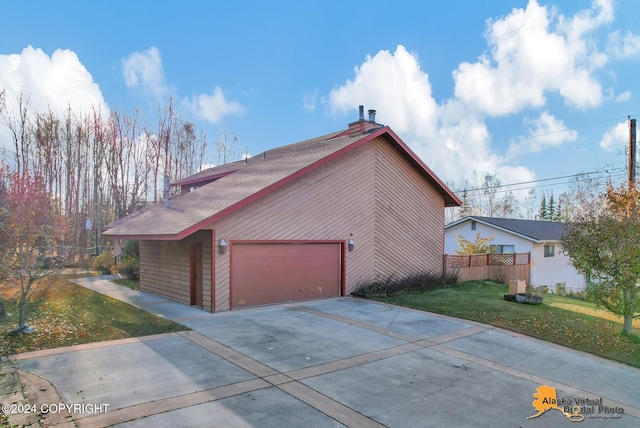 view of side of property featuring a yard and a garage