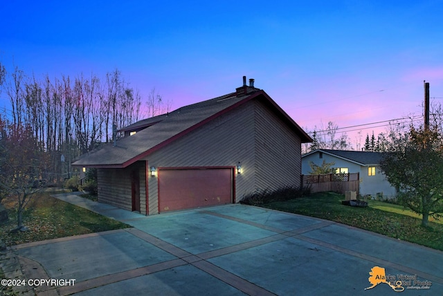 view of front of house featuring a yard and a garage