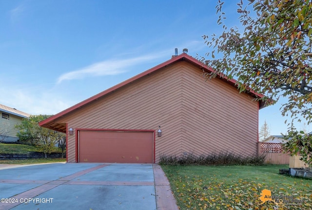 view of side of home with a yard and a garage