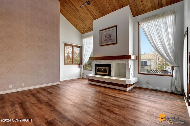 unfurnished living room featuring hardwood / wood-style floors, wood ceiling, and high vaulted ceiling