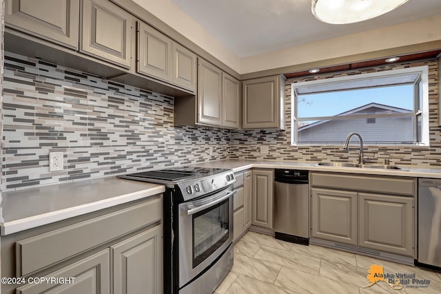 kitchen featuring sink, stainless steel appliances, and backsplash