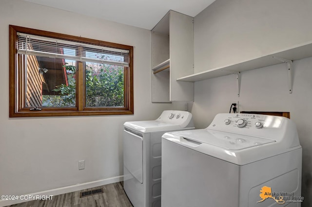 washroom featuring washer and clothes dryer and wood-type flooring