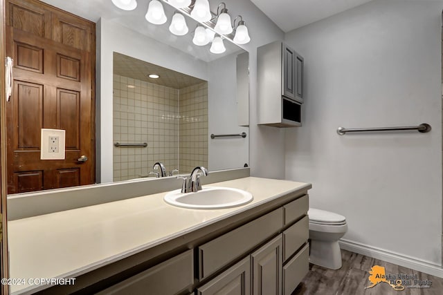 bathroom with vanity, hardwood / wood-style floors, and toilet