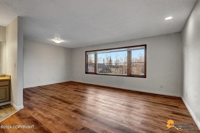 unfurnished living room with hardwood / wood-style flooring