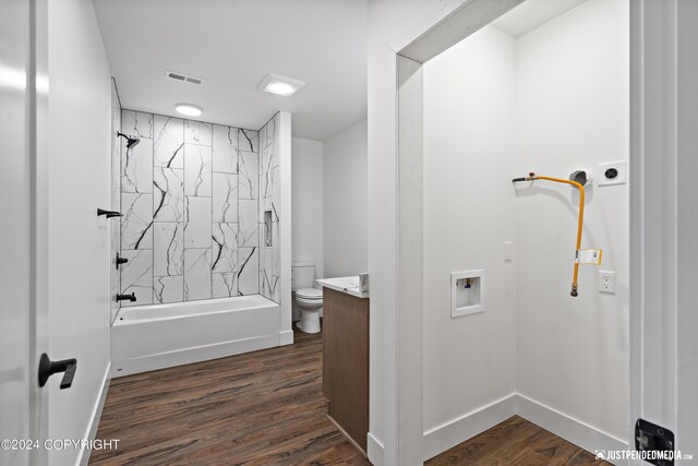 5376 Sandhill Loop, Anchorage, AK 99502 - bathroom with toilet, visible vents, wood finished floors, vanity, and tub / shower combination