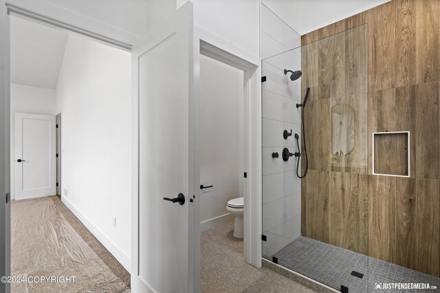 5376 Sandhill Loop, Anchorage, AK 99502 - bathroom with baseboards, toilet, and tiled shower